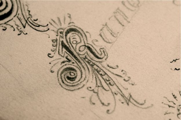 pencilled-versal-lettering Close-up photograph of an R versal